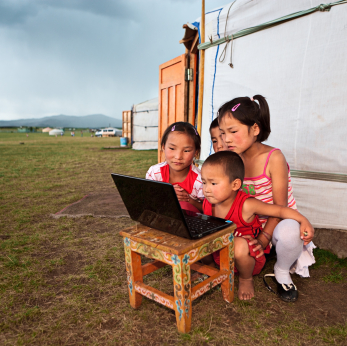 Mongolian children study at a computer