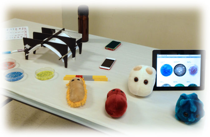 Our experimental setup: Microbe plushies, Lego DNA, plates, iPhones and makeshift stand, ready to go.