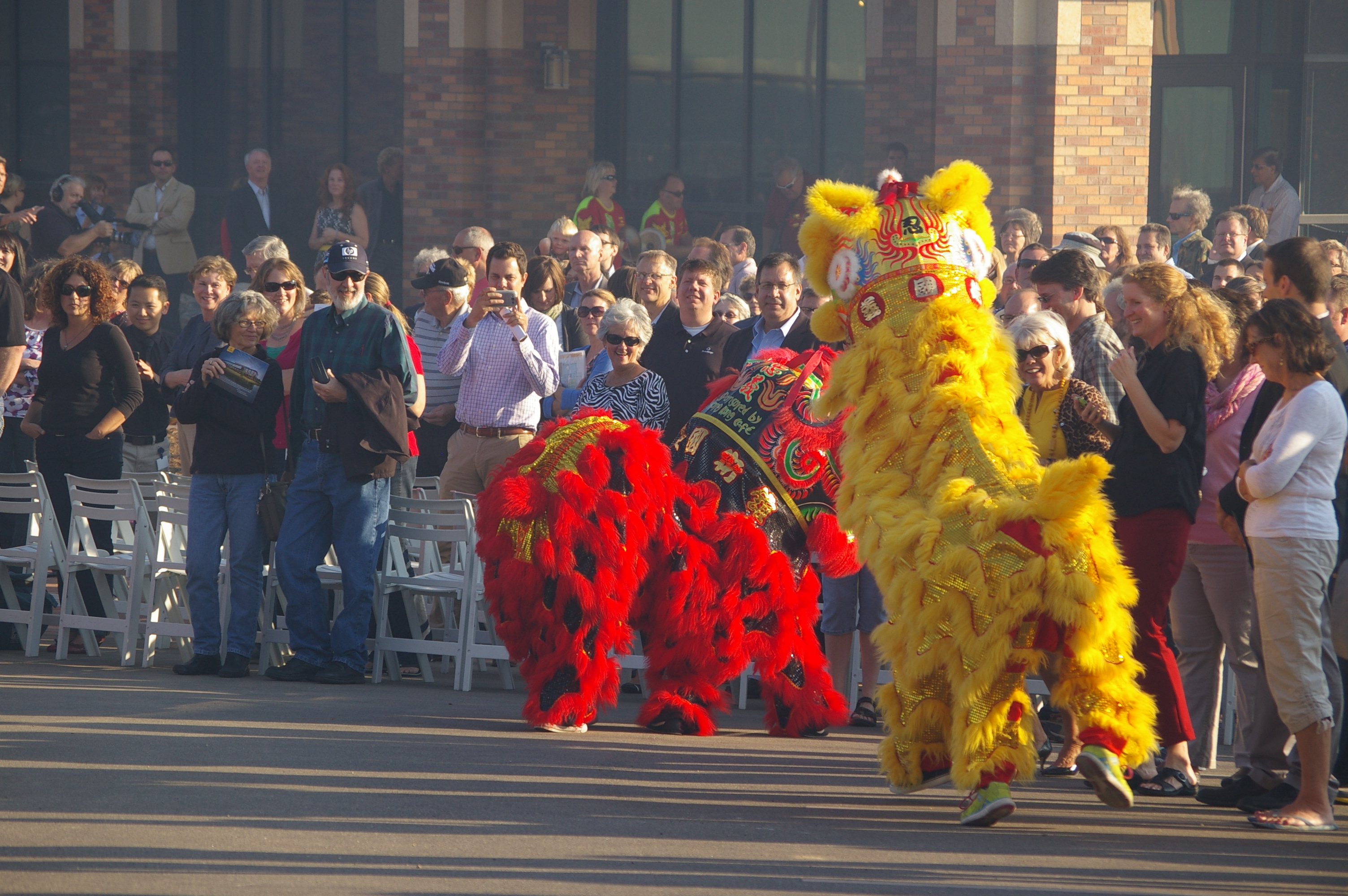 Forget the ribbon cutting, we have fireworks and dragons dancing and playing with the crowd.