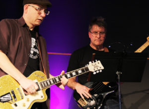 Brad Graham (guitar) and Todd Swanson (bass) play with Lead Generation at the Promega Employee Recognition Meeting.