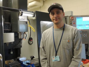 Travis Beyer, Machinist Technician, at the CNC milling machine in the Promega machine shop.