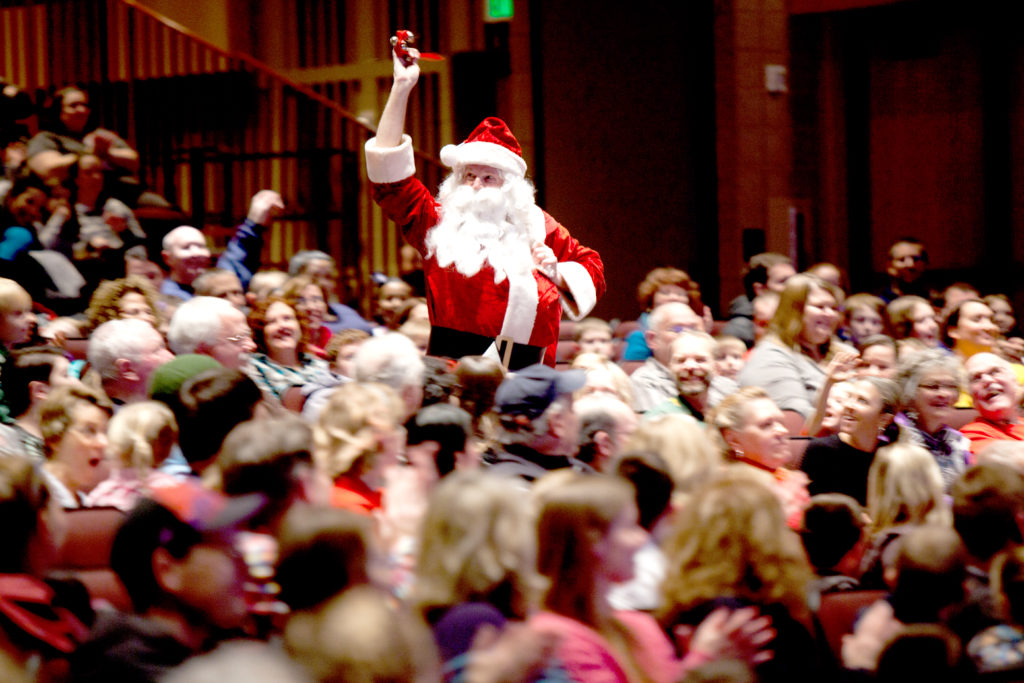 Santa walking down the aisle at the 49th Once Upon a Christmas Cheery show