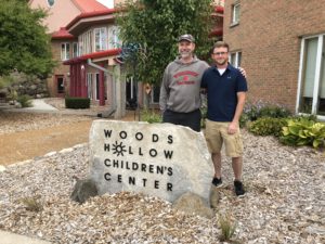 Tyler and his dad pose outside Woods Hollow.