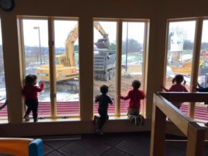 Children at Woods Hollow watch with fascination as the construction crews get to work.