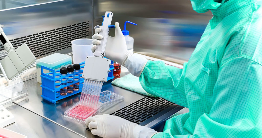 Scientist performing a multi-well assay. Same-well multiplexing enables you to look at one event from several perspectives.