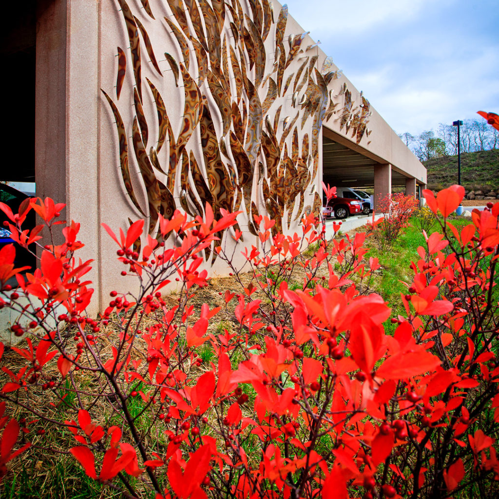 This metal sculpture adorns the parking garage that serves Promega Kornberg and Feynman buildings on the Madison, WI, USA campus.