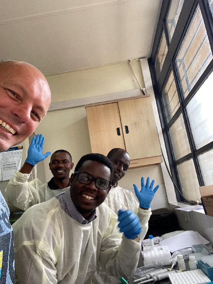 Henk Honing poses with three trainees during user training on the Maxprep Liquid Handler