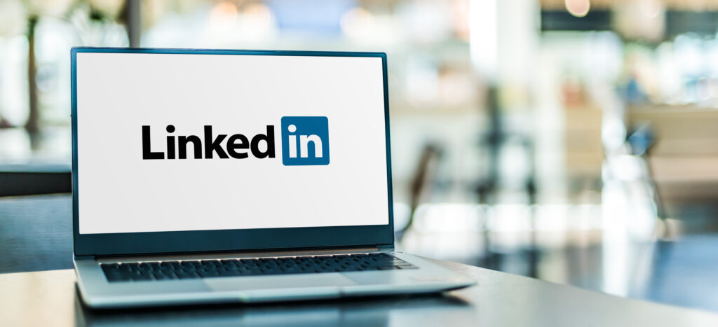 Laptop computer displaying logo of LinkedIn, an American business and employment-oriented service that operates via websites and mobile apps