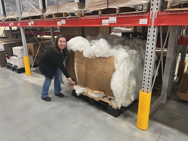 Melanie Preston poses with the first plastic film bale prepared at Kepler Center